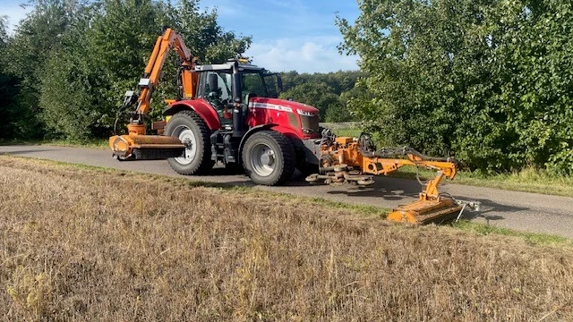 Billede af en traktor med græsklippere monteret foran og bagpå